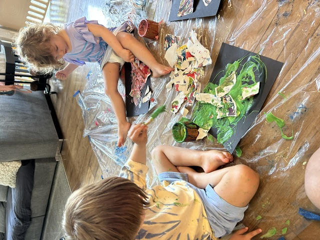 Two children creating collage