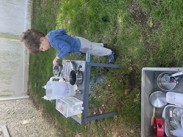 Toddler at mud kitchen