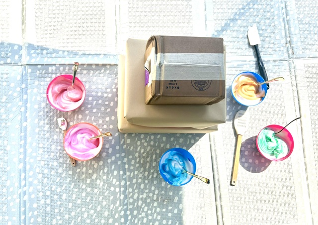 Overhead view of pastel paint mixing bowls