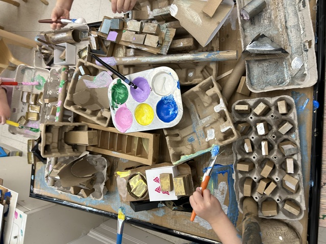 Children painting cardboard