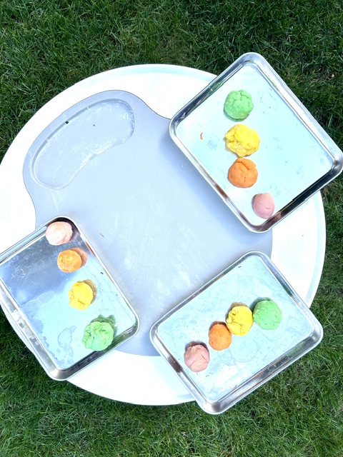 Overhead view of colorful play dough on trays