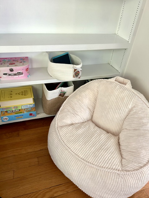 Reading nook with shelving and a cozy bean bag chair
