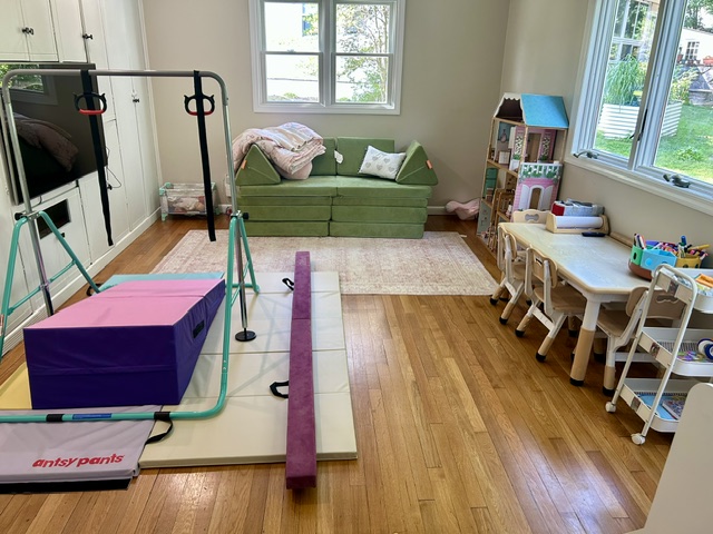 Movement space with gymnastics bar, mats, and balance beam